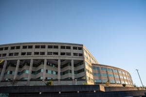 The view of the back side of the Natural Resources Building from the northeast. This side of the building has a curved portion that leads into a bigger, geometric area with unique features and angles.