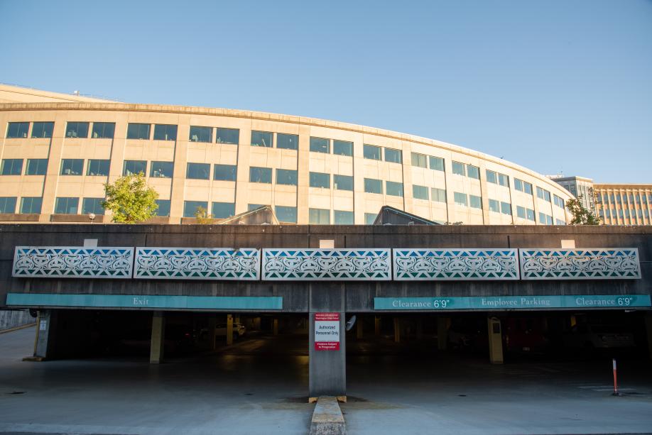 The five identical panels of the Sea to Sky mural hang above the Department of Natural Resources building's employee parking garage.