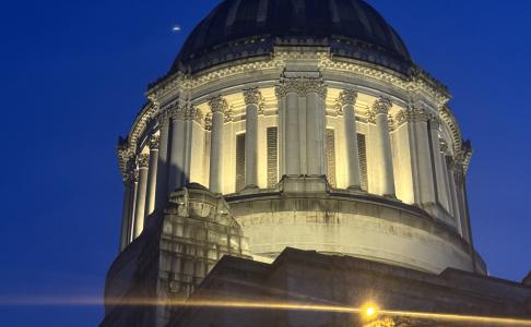 The Legislative Building's dome lit up at night following repair work. The area surrounding the dome is bright.