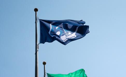 The Seattle Seahawks' 50th season flag waving on a flagpole.