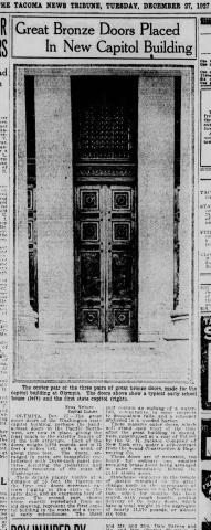 A newspaper clipping with the headline "Great Bronze Doors Placed In New Capitol Building" and a black and white photo of a set of large doors.