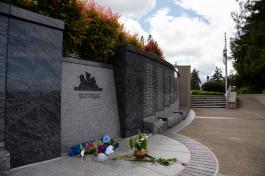 The Law Enforcement Memorial, made of cement and granite, has flowers placed in front of it to honor law enforcement personell who lost their lives while serving.