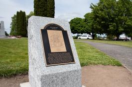 The Olmsted Legacy Marker, a detailed bronze plaque set in a granite pedestal, stands near the center the West Campus lawn between the Medal of Honor Memorial and Tivoli Fountain.