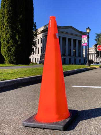 Cones marked closed parking spaces on the South Diagonal with the Capitol Building and blue sky in the background