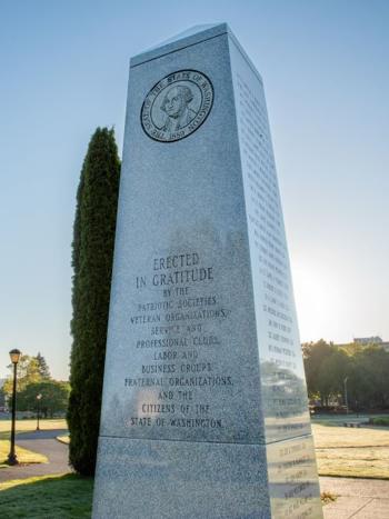 The Washington State Medal of Honor Memorial, with a green expanse of lawn in the background.