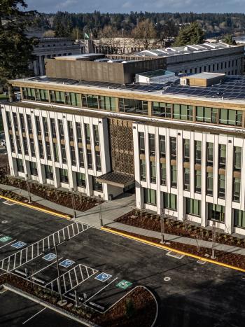 An aerial view of the Newhouse Building from the south side. Parts of the West Campus lawn and the Capitol Group buildings are visible in the background. Photo courtesy of TVW.