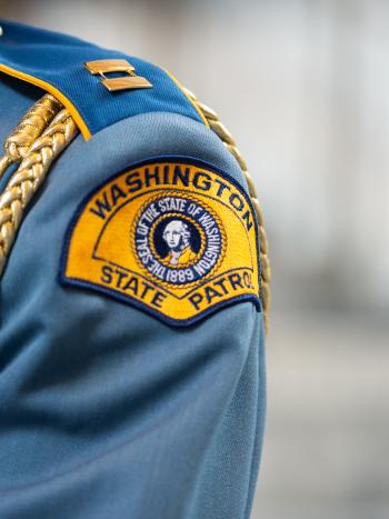 An image of the right shoulder of a uniformed member of the Washington State Patrol.