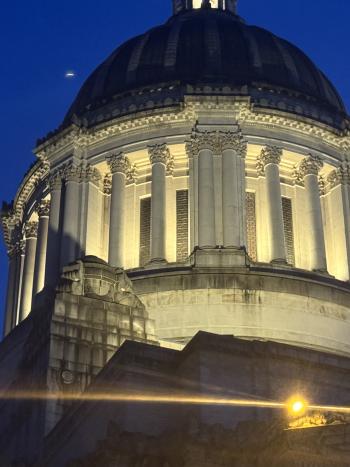 The Legislative Building's dome lit up at night following repair work. The area surrounding the dome is bright.