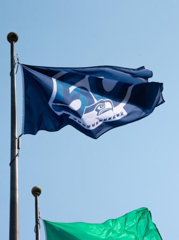 The Seattle Seahawks' 50th season flag waving on a flagpole.