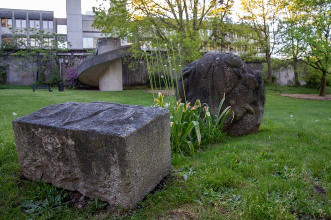 An image of the Mysteries of Life statue with the Transportation building in the background.