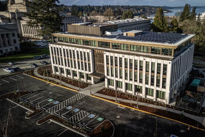 An aerial view of the Newhouse Building from the south side. Parts of the West Campus lawn and the Capitol Group buildings are visible in the background. Photo courtesy of TVW.