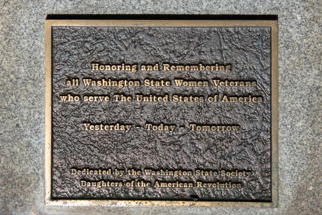 The bronze Women Veterans plaque set in a concrete base.